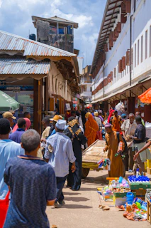 a group of people walking around a market