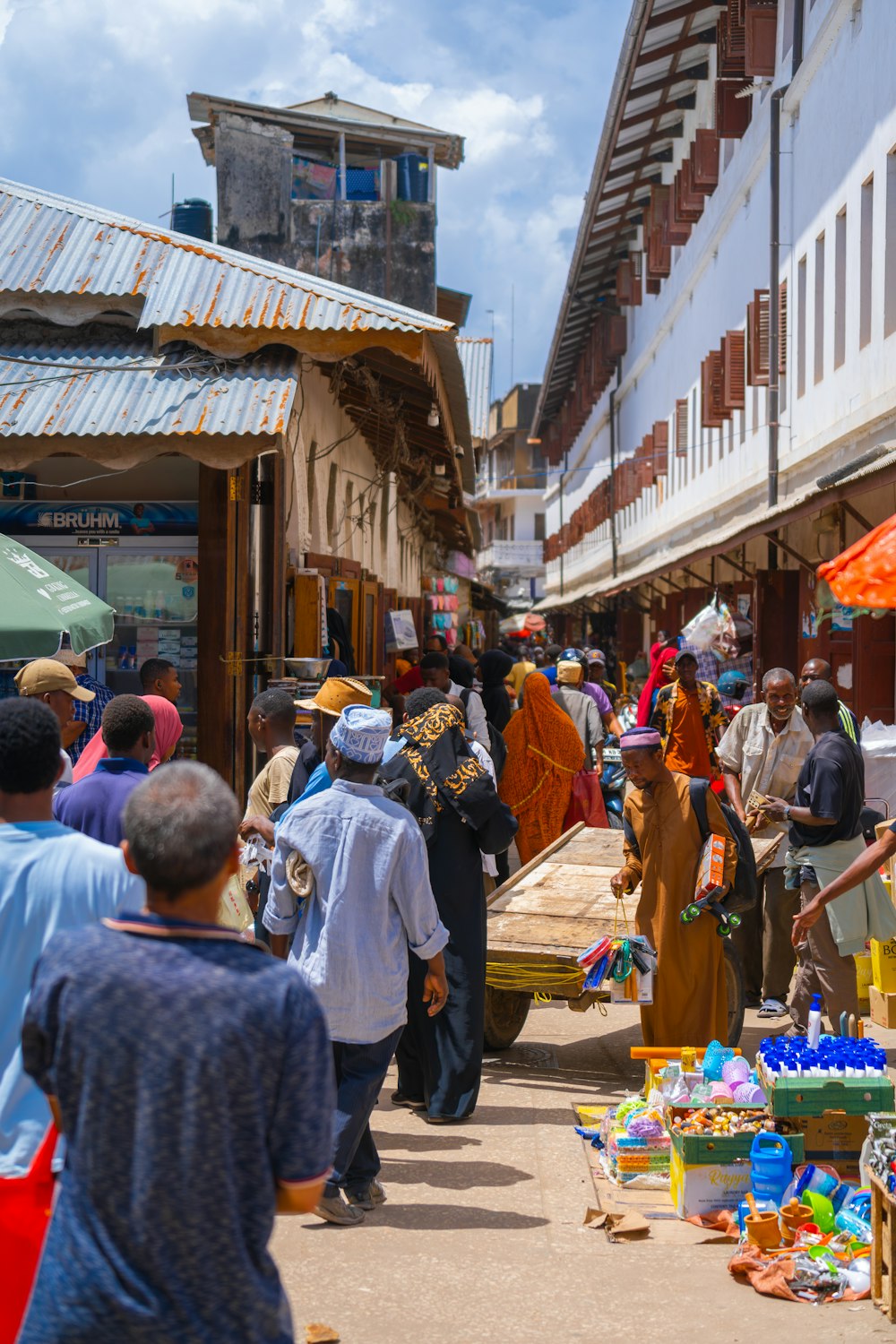 a group of people walking around a market