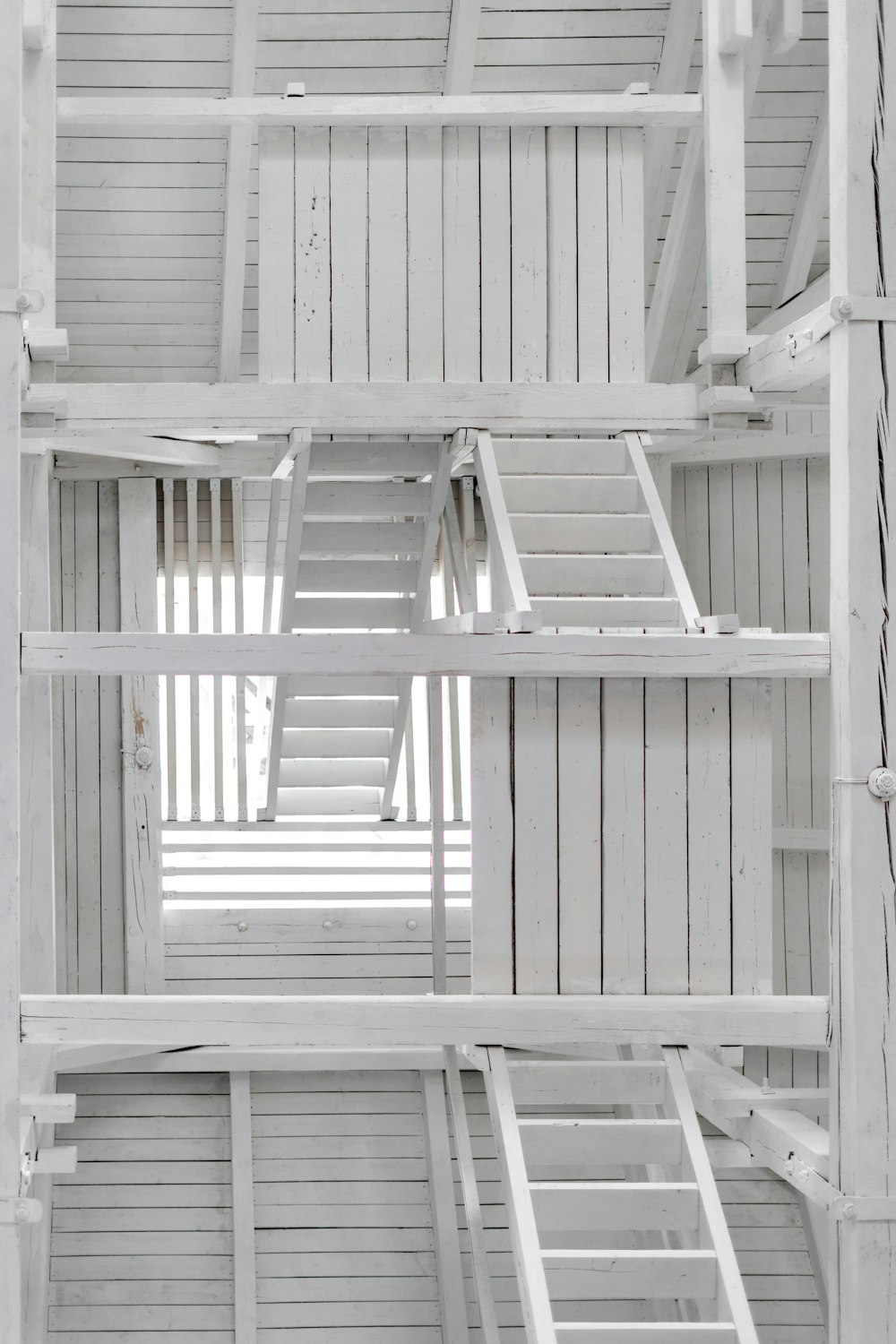 a white room with a ladder in the middle of it