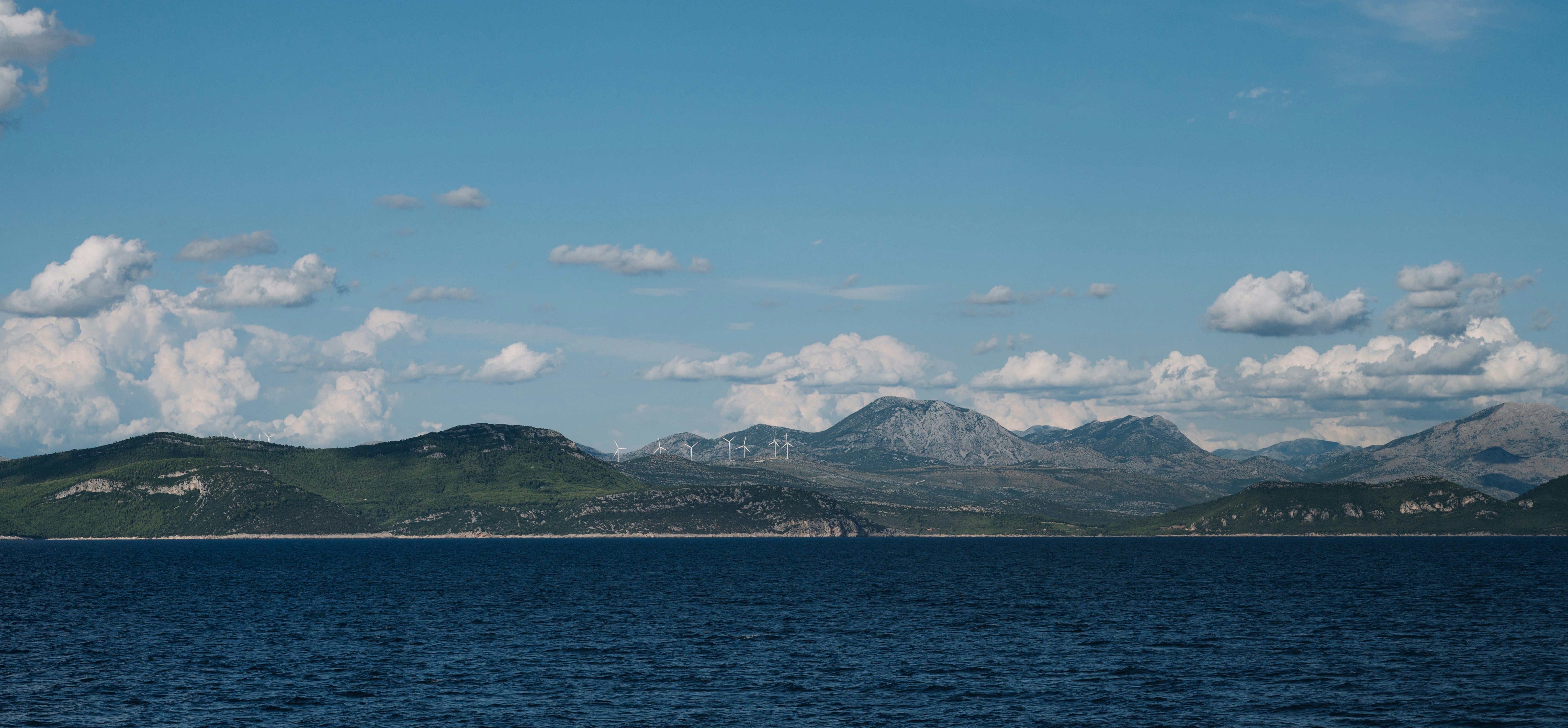 a large body of water with mountains in the background