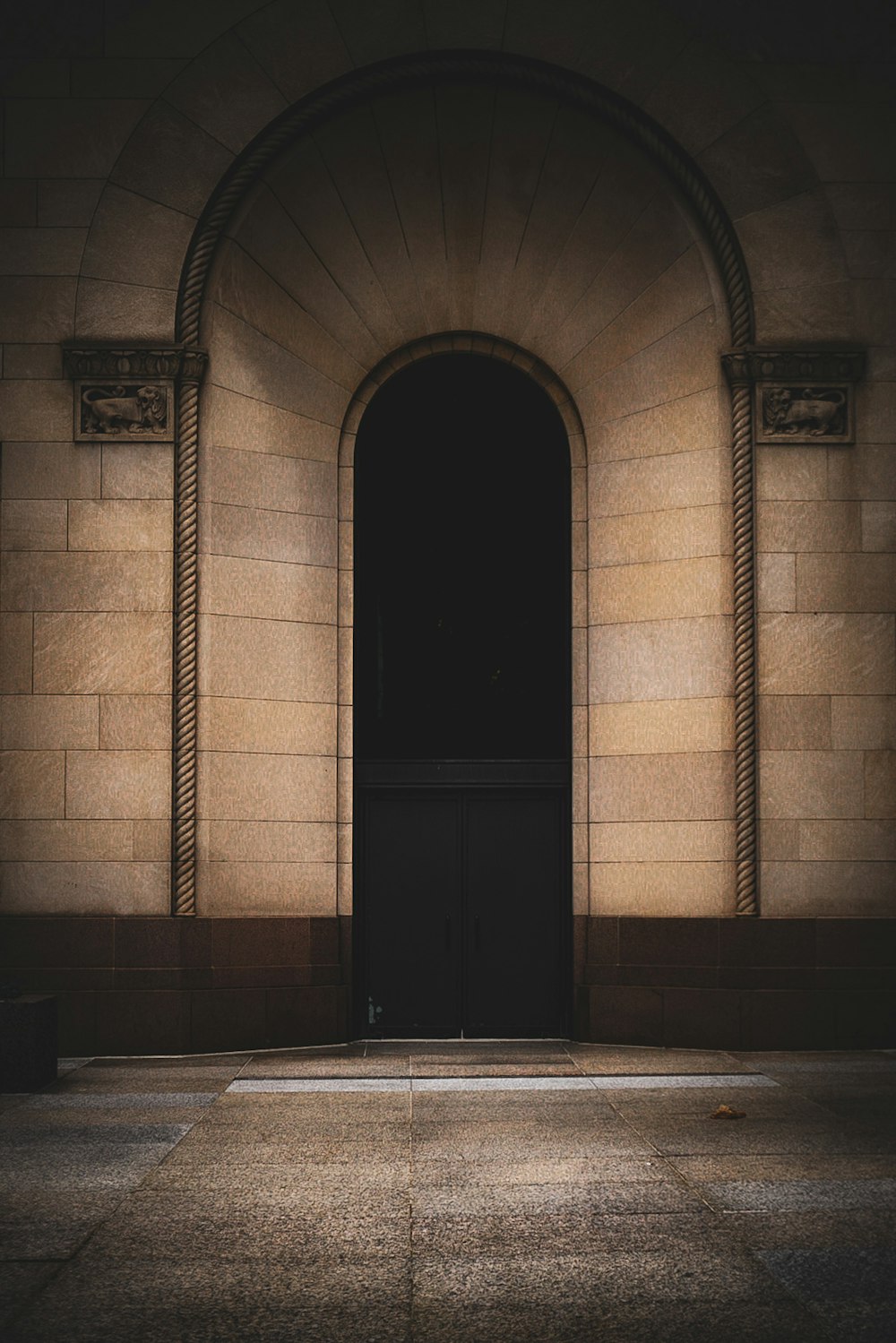 a black door in a stone building at night