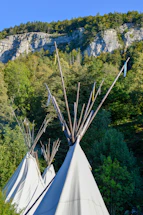 A welcoming tribal council building surrounded by nature under a clear sky.