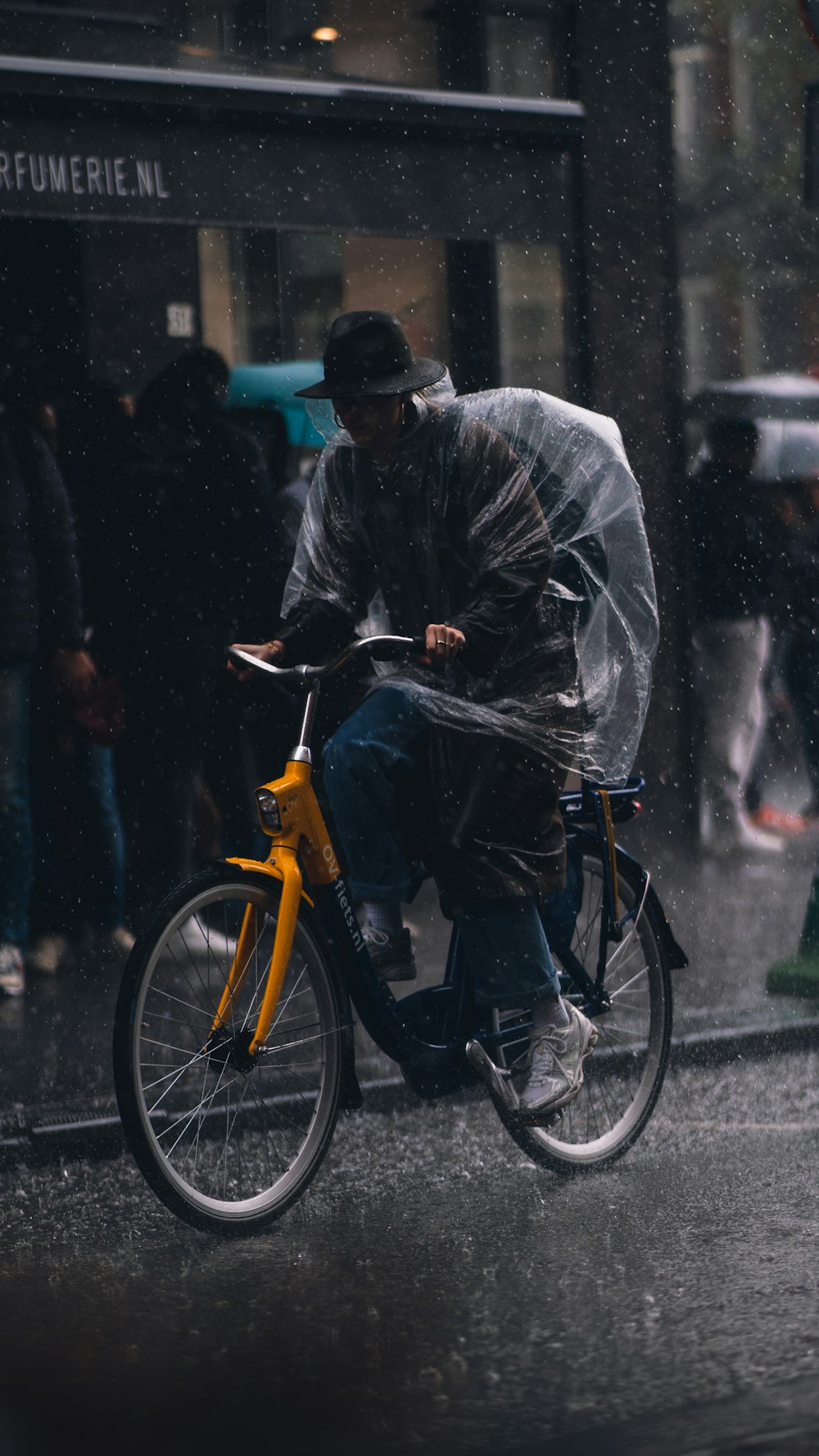 a man riding a bike in the rain