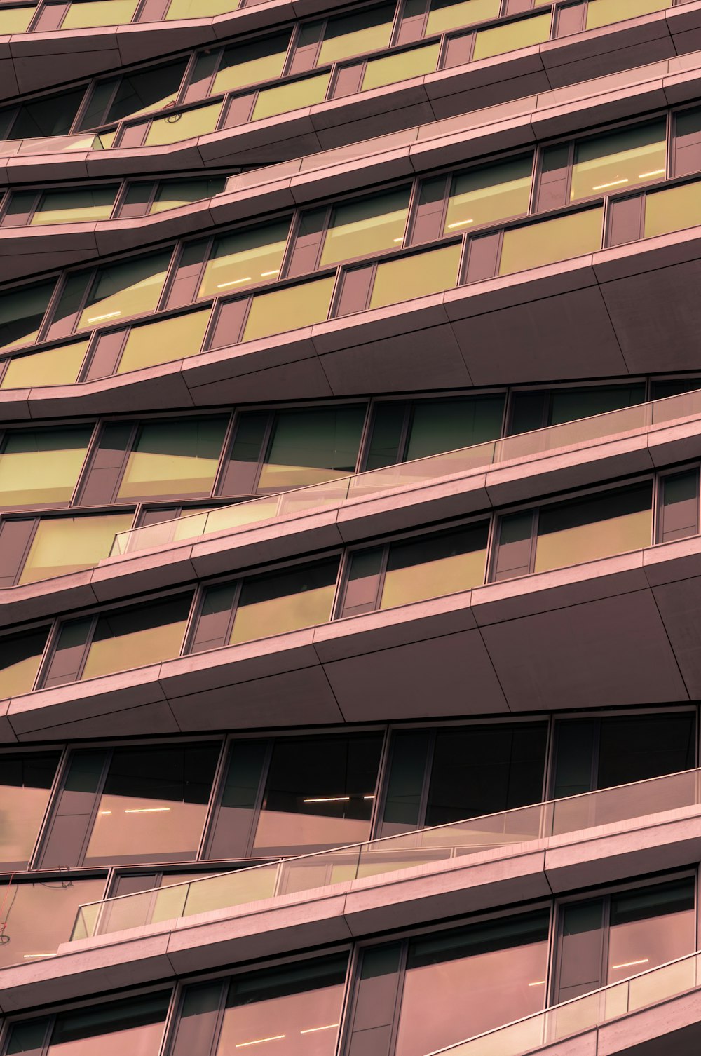 a tall building with lots of windows next to a street sign