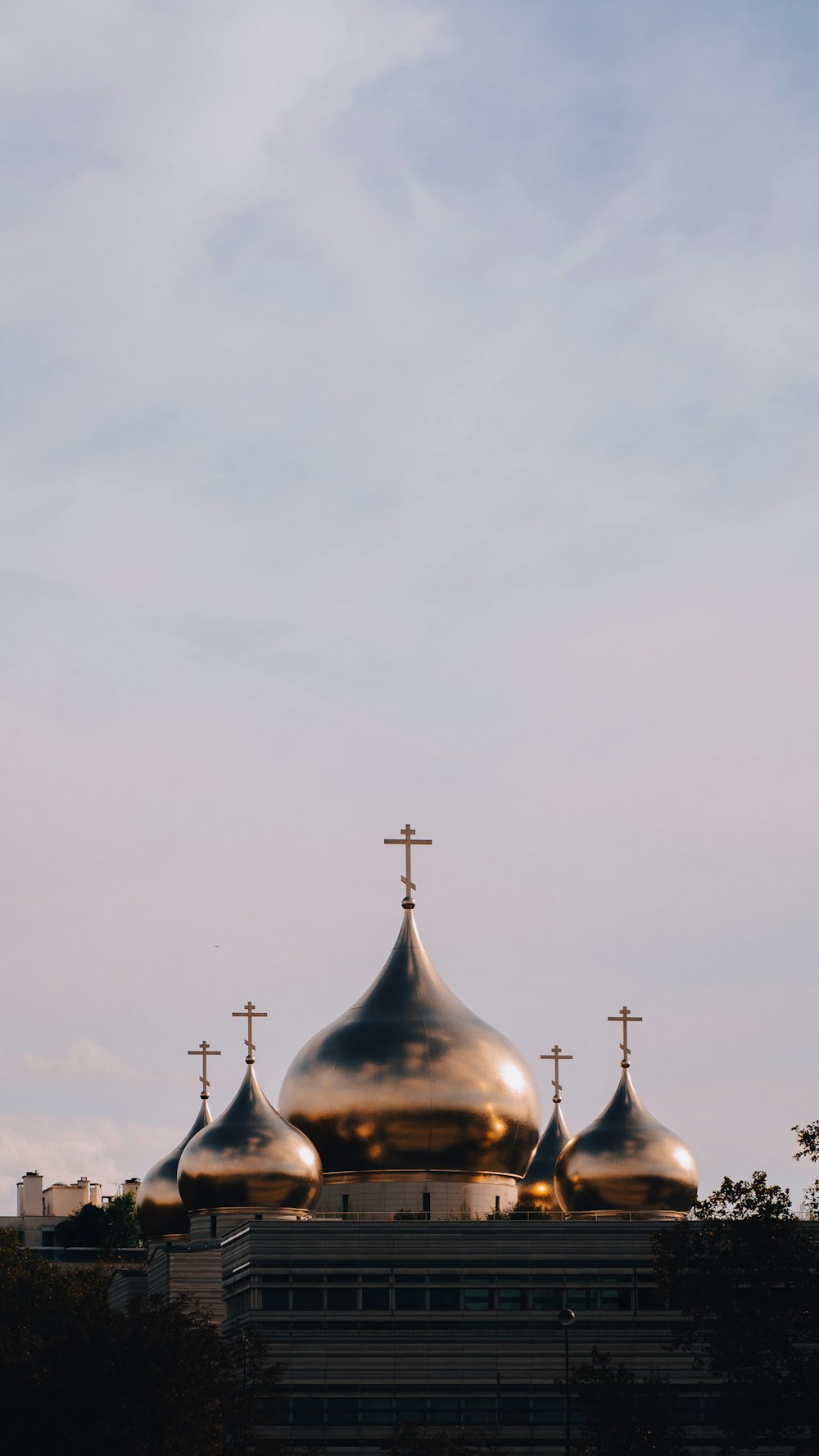 a golden domed building with three crosses on top