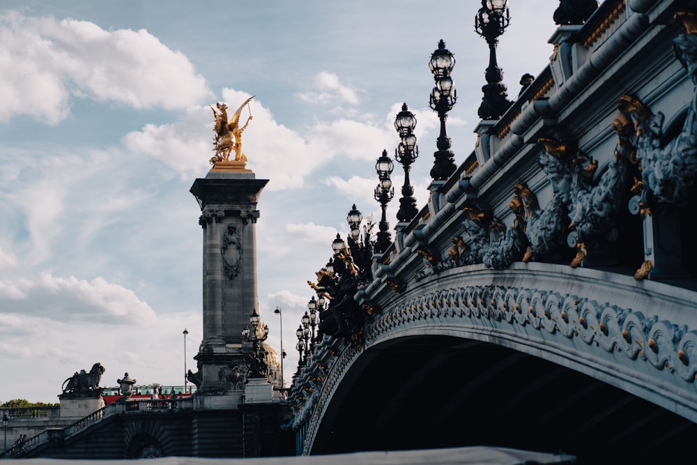 a bridge with a clock tower in the background