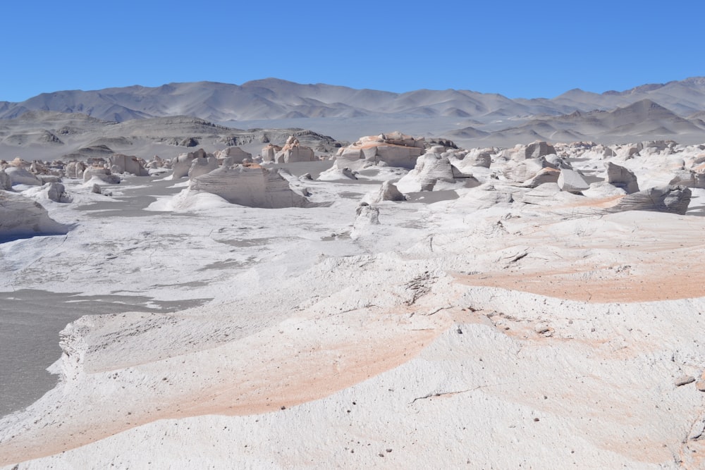 a desert landscape with mountains in the background