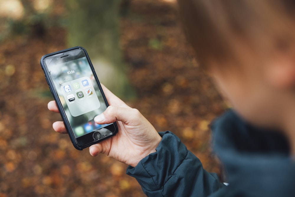 a person holding a cell phone in their hand