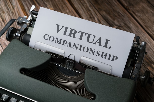 An old-fashioned typewriter with the words 'Virtual Companionship' typed on a sheet of paper. The image includes a green typewriter and a wooden surface background.
