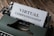 An old-fashioned typewriter with the words 'Virtual Companionship' typed on a sheet of paper. The image includes a green typewriter and a wooden surface background.