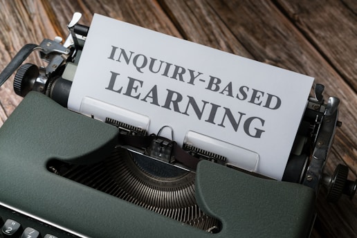 a close up of a typewriter with an inquiry - based learning paper