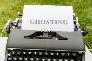 a close up of a typewriter with a ghosting sign on it