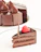 Close-up of a rich chocolate cake with raspberry filling and elegant frosting swirls