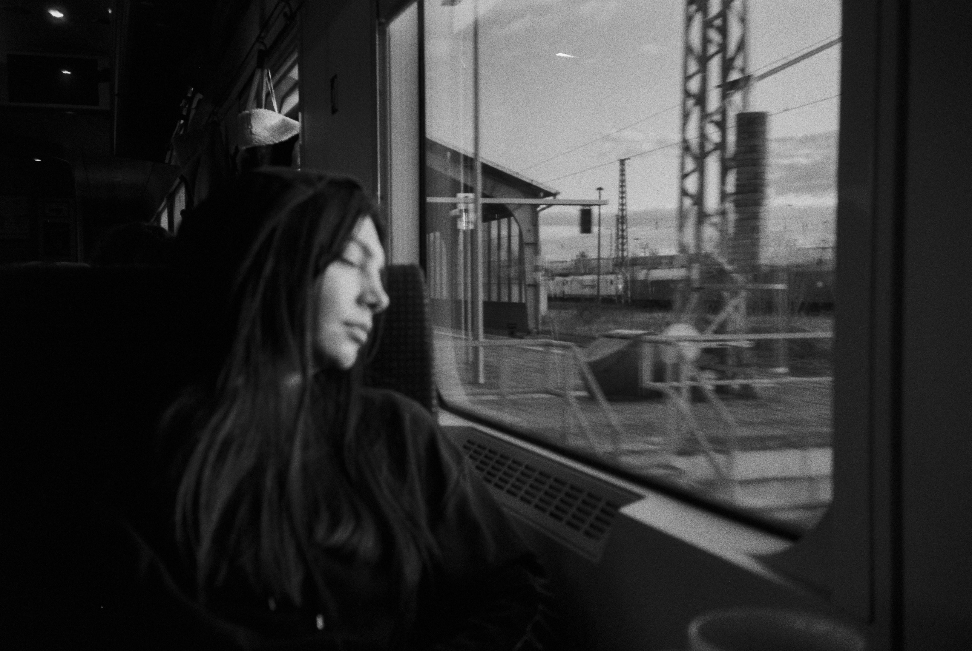 a woman sitting on a train looking out the window