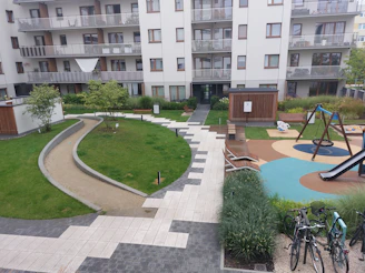 Happy families enjoying community spaces in a newly built apartment complex.