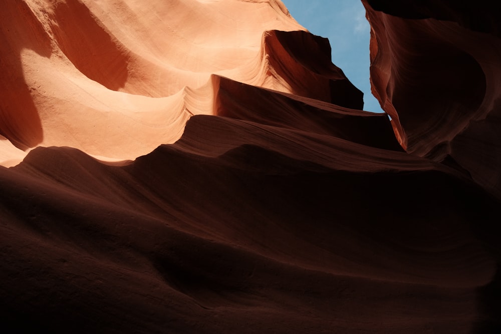 a large rock formation with a sky in the background