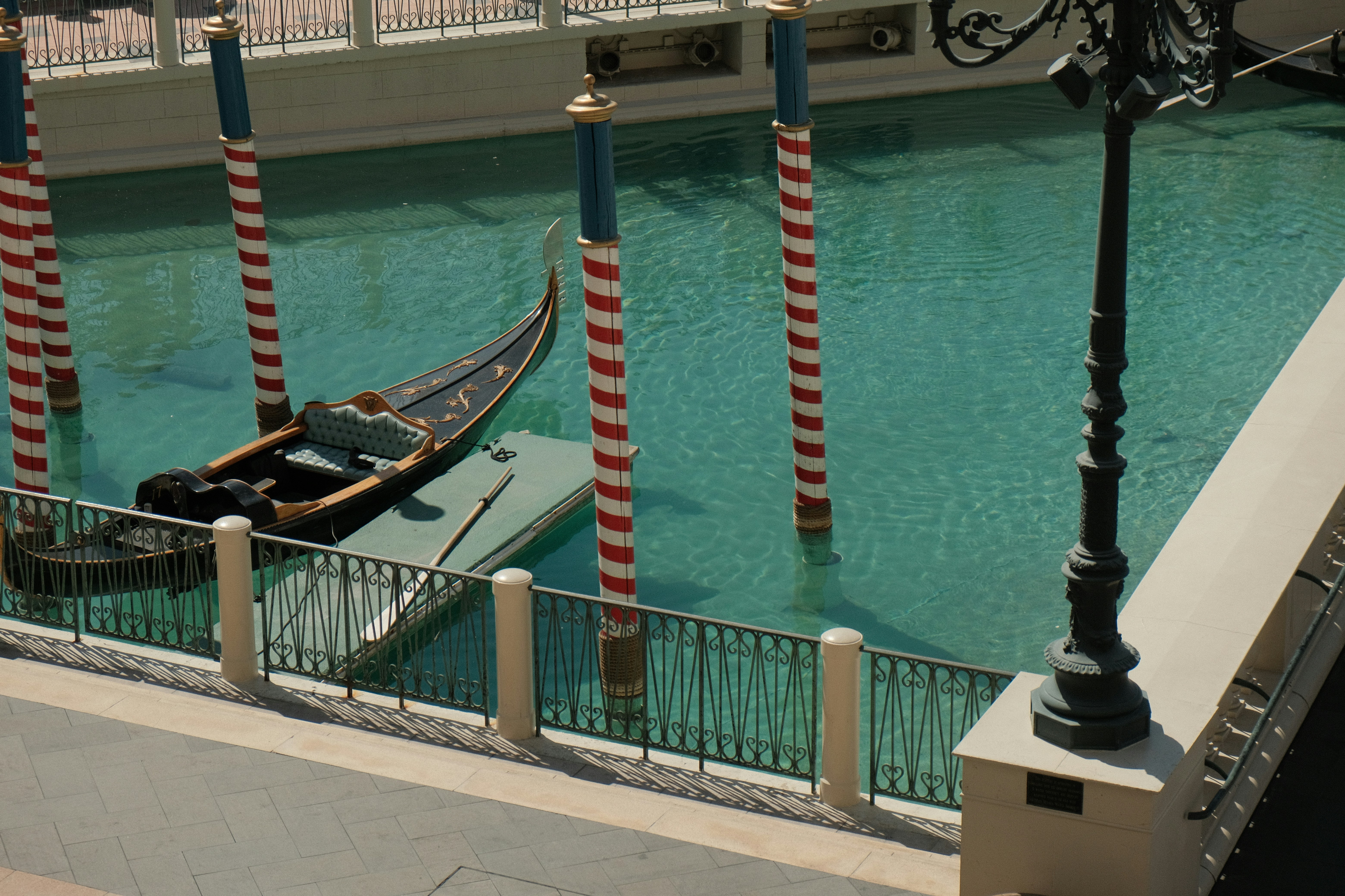 a gondola is tied to a pole in a canal
