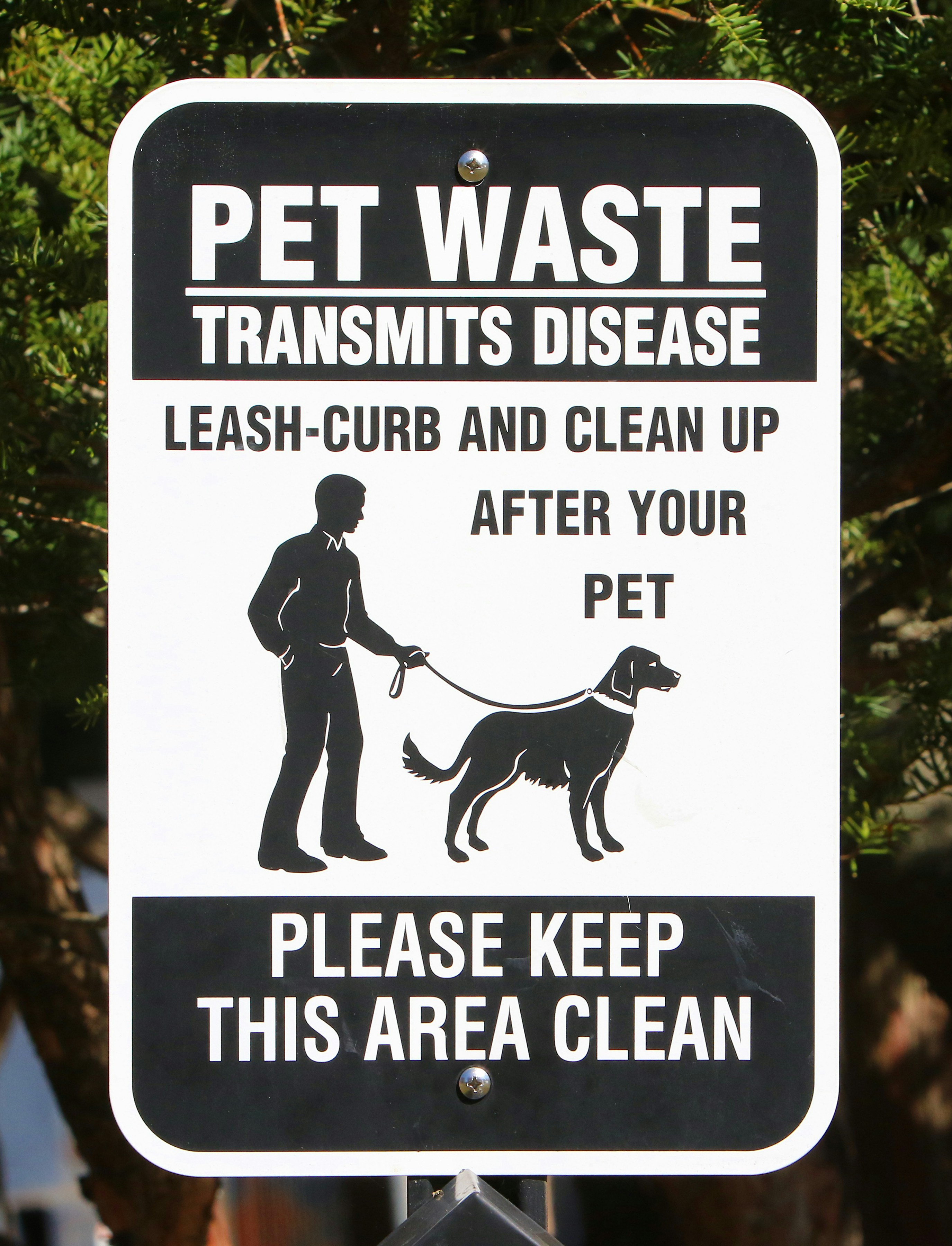 a black and white sign with a dog on it