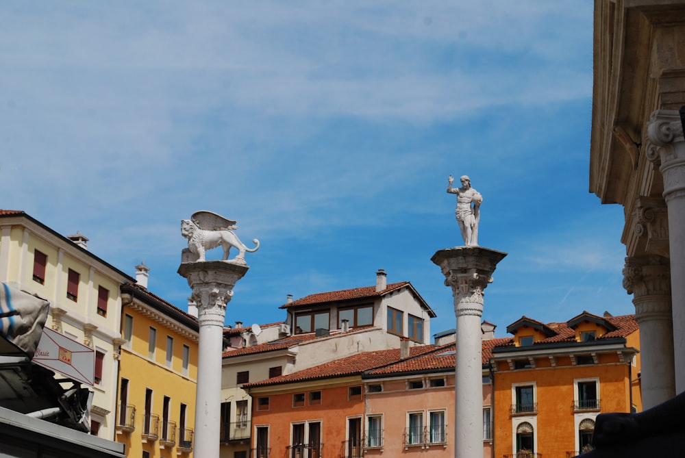 a row of buildings with statues on top of them