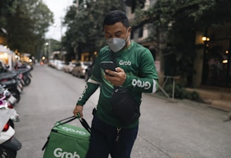 Frontline worker checking mobile for orders