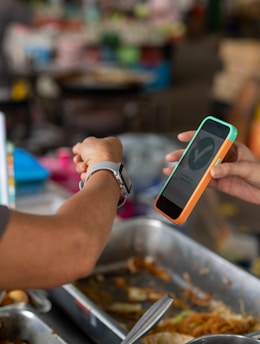 a person handing another person a cell phone