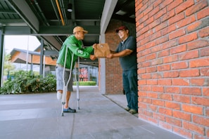 a man in a green jacket and a man in a blue shirt are holding a