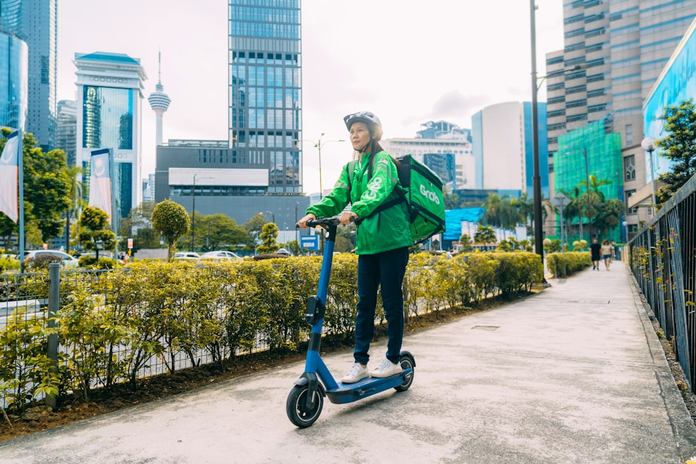 a person riding a scooter on a city street