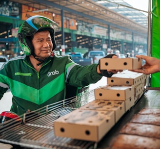a man wearing a helmet and holding a box