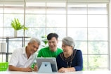 a couple of people that are looking at a tablet