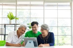 Staff attending tables with smiles while a tablet shows reservation details
