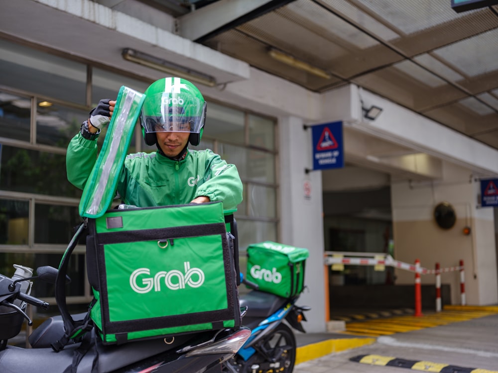 a man in a green outfit riding a motorcycle