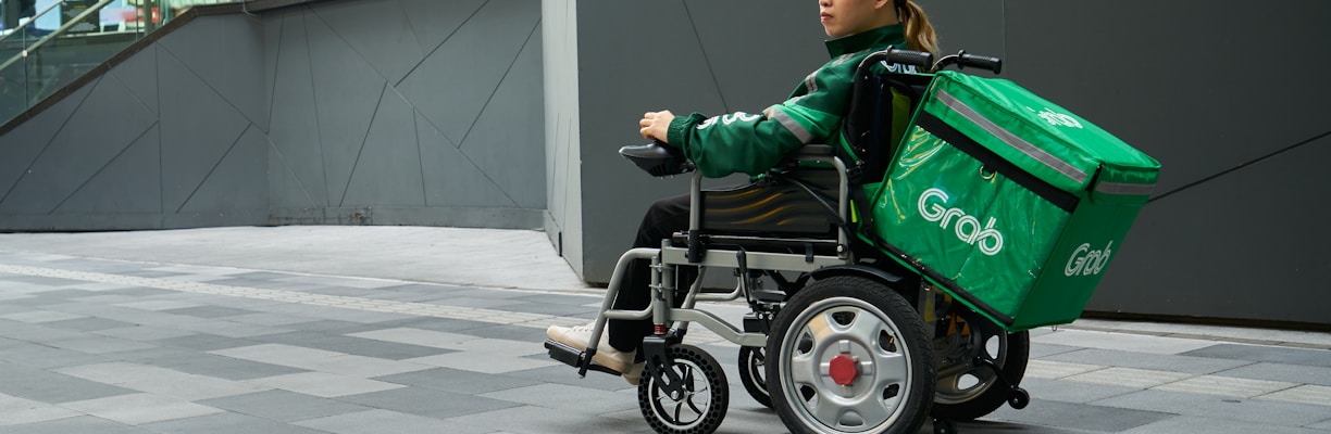 a woman in a wheel chair with a green cooler