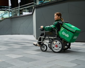 a woman in a wheel chair with a green cooler