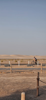 A cyclist riding through the dunes of the Sahara.