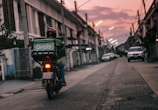 a person riding a motorcycle down a street