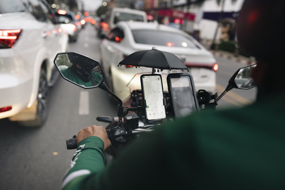 a man riding a motorcycle down a street next to traffic