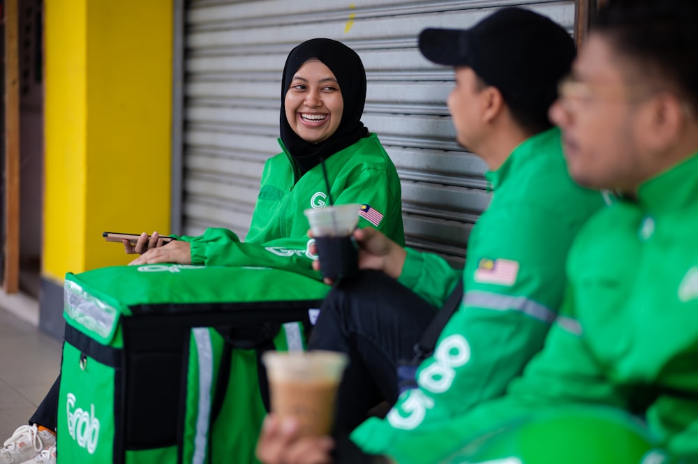 a woman in a green outfit sitting on a bench