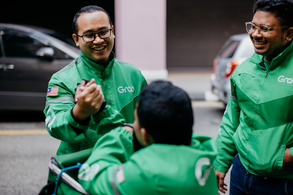 a group of men in green jackets standing next to each other