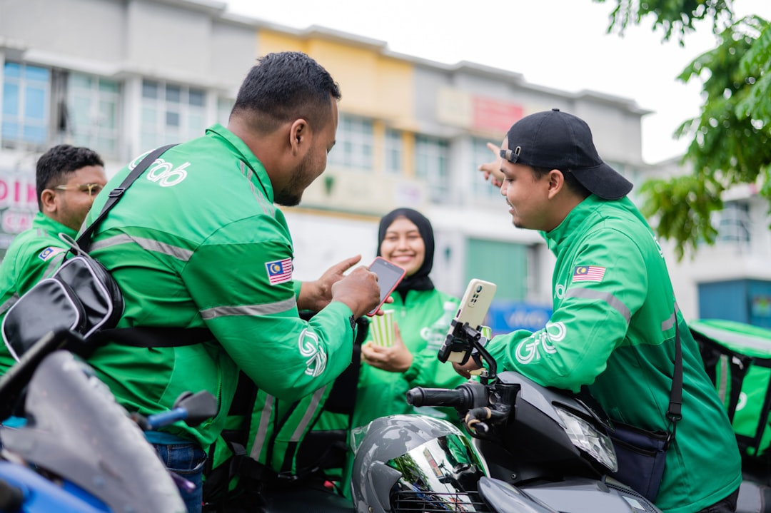 a group of people in green jackets on a motorcycle