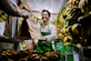 A smiling man unpacking fresh groceries delivered from el guiouan market.