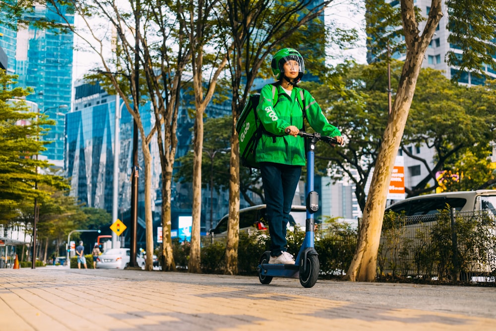 a person riding a scooter on a city street