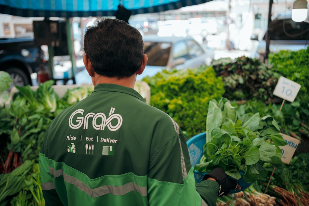 a man standing in front of a bunch of vegetables,