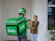 Delivery person smiling while handing groceries to a customer at home doorstep.