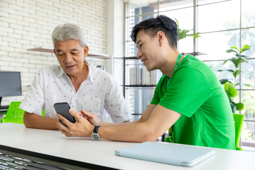 a man and a woman looking at a cell phone,