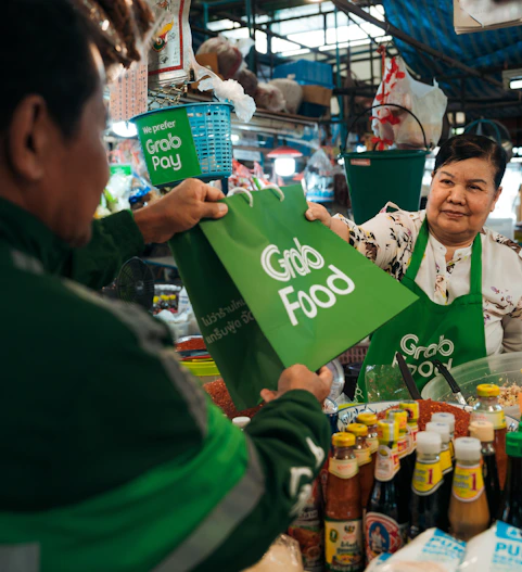 a woman holding up a green sign in front of a man