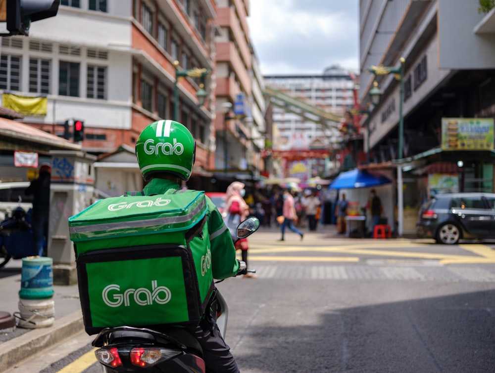 a person on a motor bike on a city street