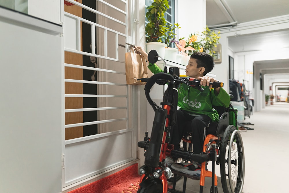 a man in a green shirt in a wheel chair