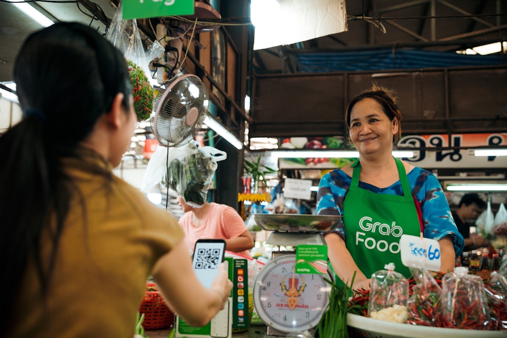 a woman standing behind a counter in a store