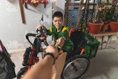 A young person with a disability receiving support and encouragement from a caring volunteer.