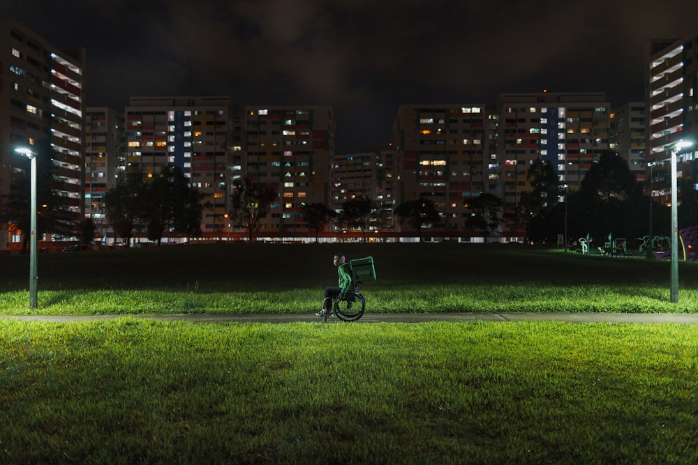 a person riding a bike at night in a park